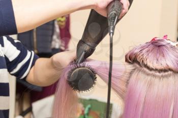 blow-drying hair in a beauty salon