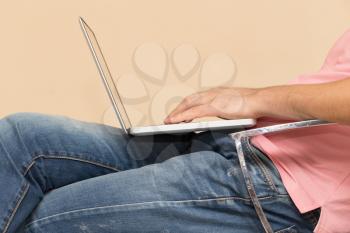 man in jeans with a laptop