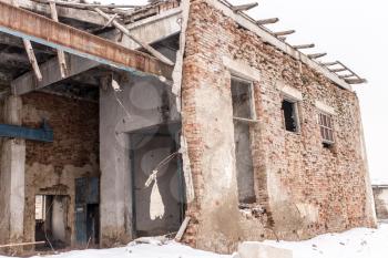 old crumbling brick house in winter