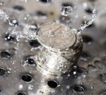 coins in a spray of water