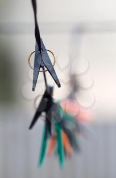 old clothes pegs hanging on a rope