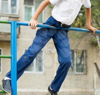 Boy training on a horizontal bar