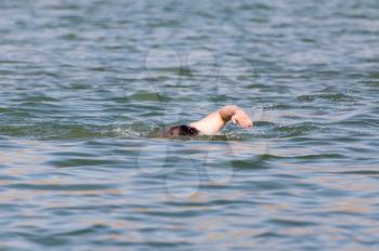 a man swimming in a lake