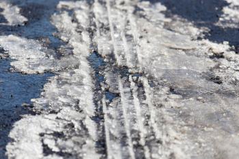 trace of the car in the snow as a background