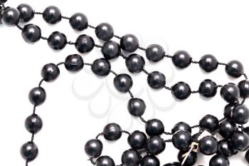 Black beads on a rope on a white background