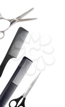 Comb with scissors and razor on a white background .