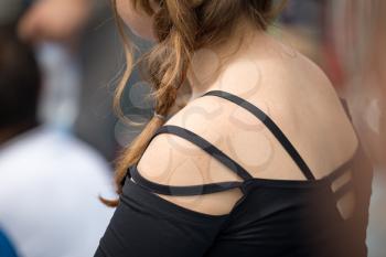 Part of the body of the girl's shoulders .