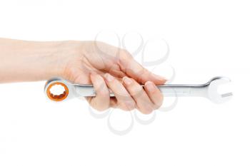 Wrench in female hand. Isolated on white.
