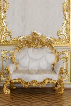 Elegant chair decorated with gold in the Palace's Central