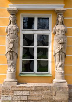 window with sculptures in the form of ancient women