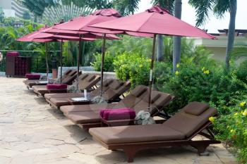 Luxury sun loungers, towels and umbrellas.