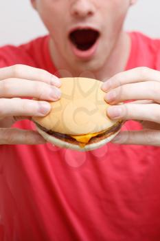 Royalty Free Photo of a Man Eating a Hamburger