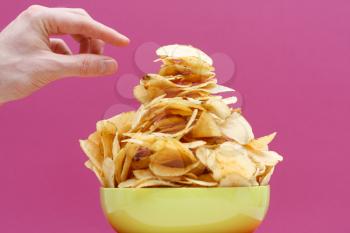 Royalty Free Photo of a Person Eating Potato Chips