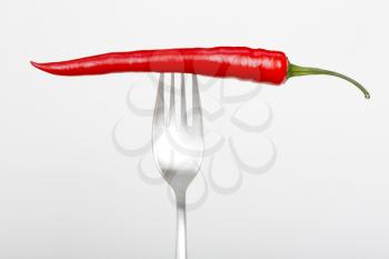 Royalty Free Photo of a Chili Pepper on a Fork