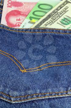 money bills on pocket of a pair of blue jeans