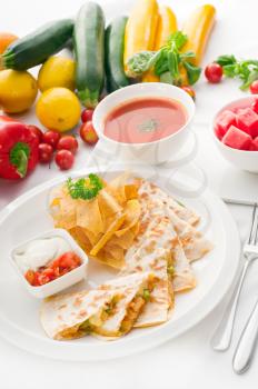 original Mexican quesadilla de pollo with nachos  served with gazpacho soup and watermelon ,with fresh vegetables on background,MORE DELICIOUS FOOD ON PORTFOLIO