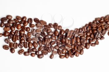 bounch of roasted coffee beans mimic a road shape