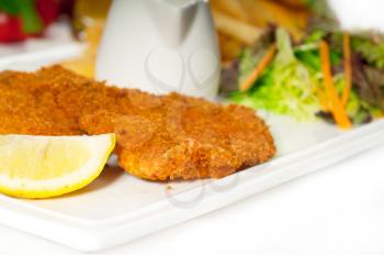 classic breaded Milanese veal cutlets with french fries and vegetables on background ,MORE DELICIOUS FOOD ON PORTFOLIO