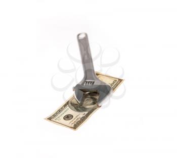 wrench tool fixing dollar bill isolated on white background  closeup