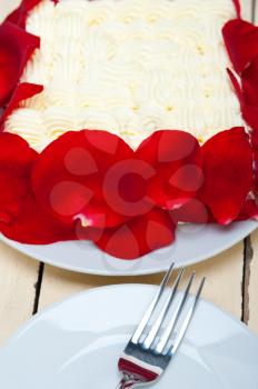 whipped cream mango cake with red rose petals 