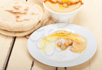 traditional chickpeas Hummus with pita bread and paprika on top 