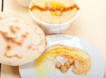 traditional chickpeas Hummus with pita bread and paprika on top 