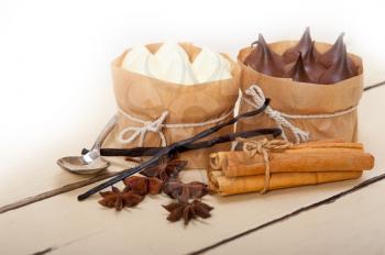 fresh baked chocolate vanilla and spices cream cake dessert over rustic wood table 