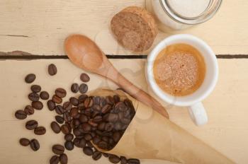 espresso coffee and beans on a paper cone cornucopia over white background