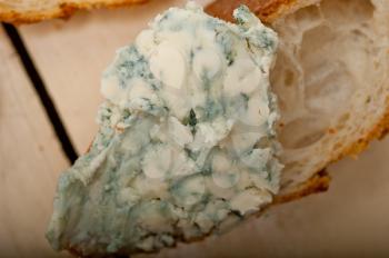 fresh blue cheese spread ove french baguette with cherry tomatoes on side