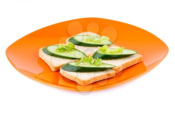 Rusk sandwiches with lettuce, cucumber on plate isolated on white background.