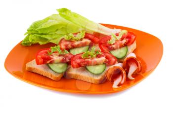 Rusk sandwiches with lettuce, tomato, cucumber and pork loin on plate isolated on white background.