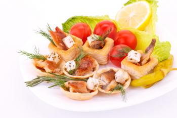 Smoked fish  and feta cheese in pastries and fresh vegetables.