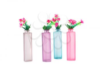 Colorful fabric flowers in glass vases isolated on white background.