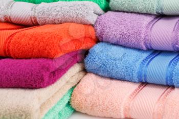 Colorful folded towels stack closeup picture.