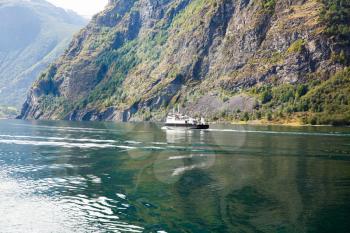 Landscape with Naeroyfjord, ship and mountains in Norway.