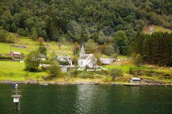 Landscape with Naeroyfjord, mountains and traditional village houses in Norway.