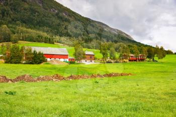 Rural place with village houses and mountains in Norway.