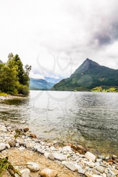 Landscape with mountains, lake and forest in Norway.