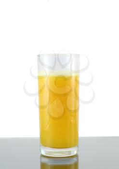Glass of fresh orange juice with squeeze slice on grey  background.