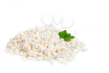 Fresh cottage cheese (curd) heap with parsley, isolated on white background.