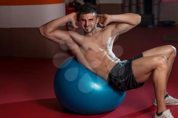 Men Working Out With An Exercise Ball