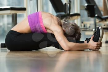 Fitness Woman Stretching On The Floor