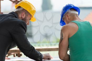 Group Of Male Architect And Construction Worker On Construction Site