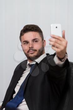 Young Businessman Working In His Office While Talking On The Phone