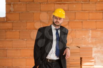 Portrait Of Business Man With Yellow Helmet On Construction