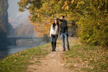 Couple Walking In Forest Through The Woods Outside During Autumn