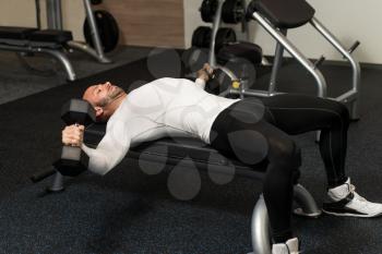 Muscular Man Doing Exercise For Chest With Dumbbells