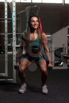 Young Woman Working Out Legs With Dumbbells - One Of The Best Bodybuilding Exercise For Leg