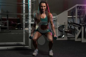 Young Woman Working Out Legs With Dumbbells - One Of The Best Bodybuilding Exercise For Leg