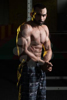 Portrait Of A Young Physically Fit Man Making Most Muscular Pose - Muscular Athletic Bodybuilder Fitness Model Posing After Exercises